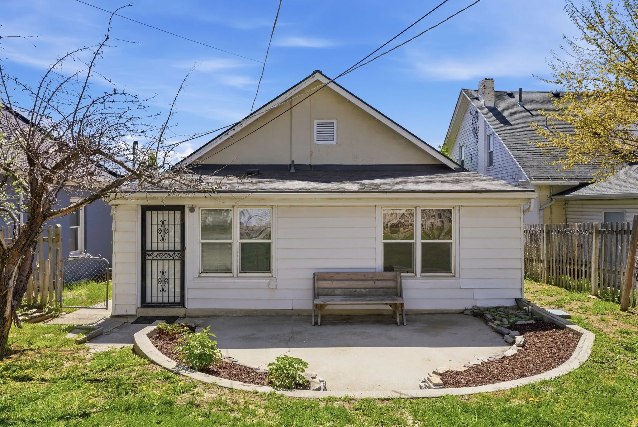 Rear view of house featuring a patio and roof with shingles