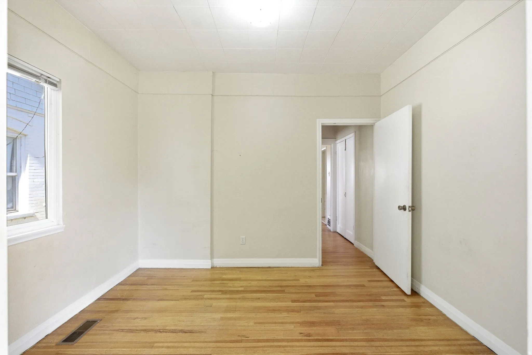 Unfurnished room featuring light wood-style floors and baseboards