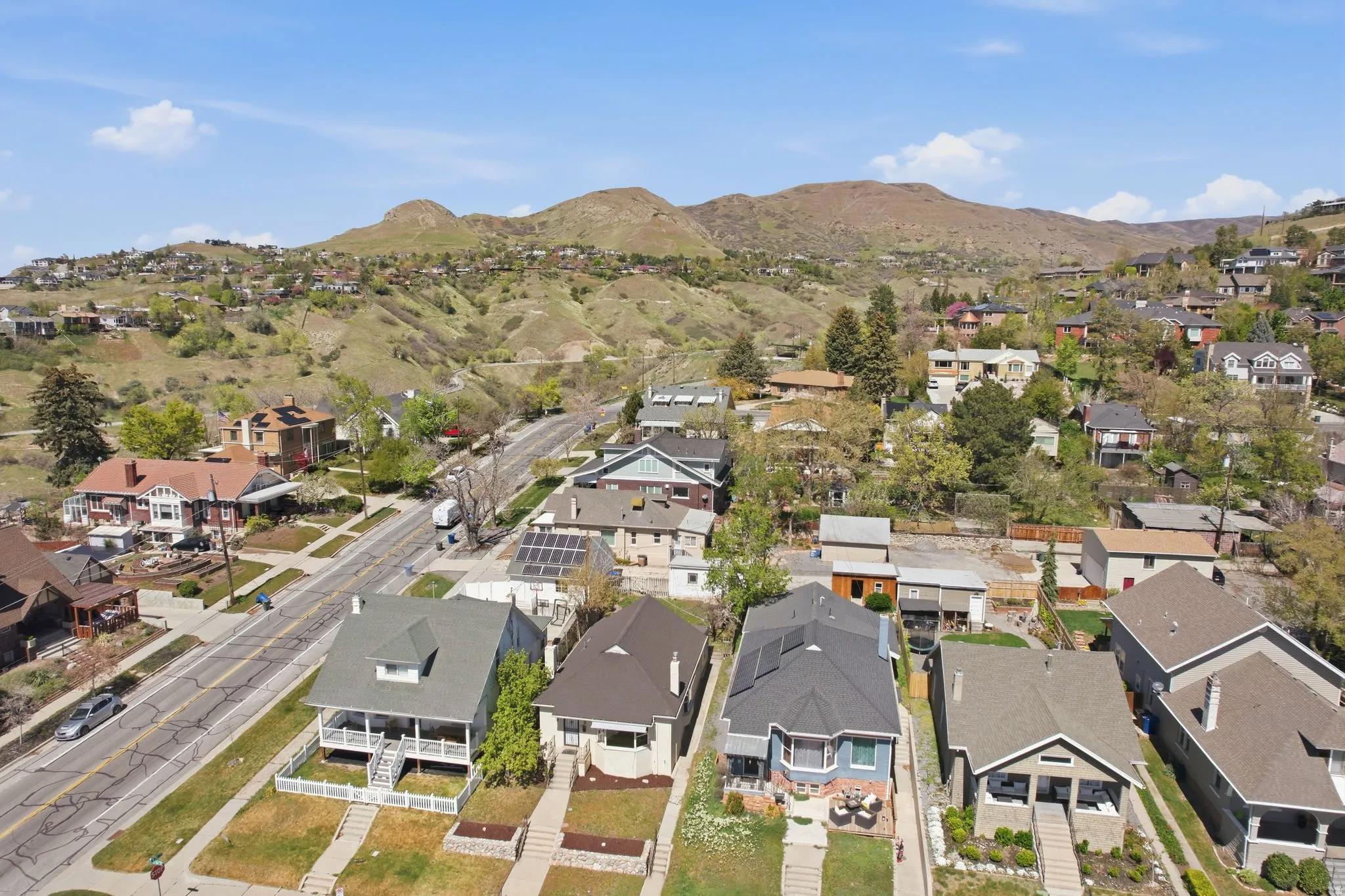 Aerial overview of property's location with nearby suburban area and a mountainous background