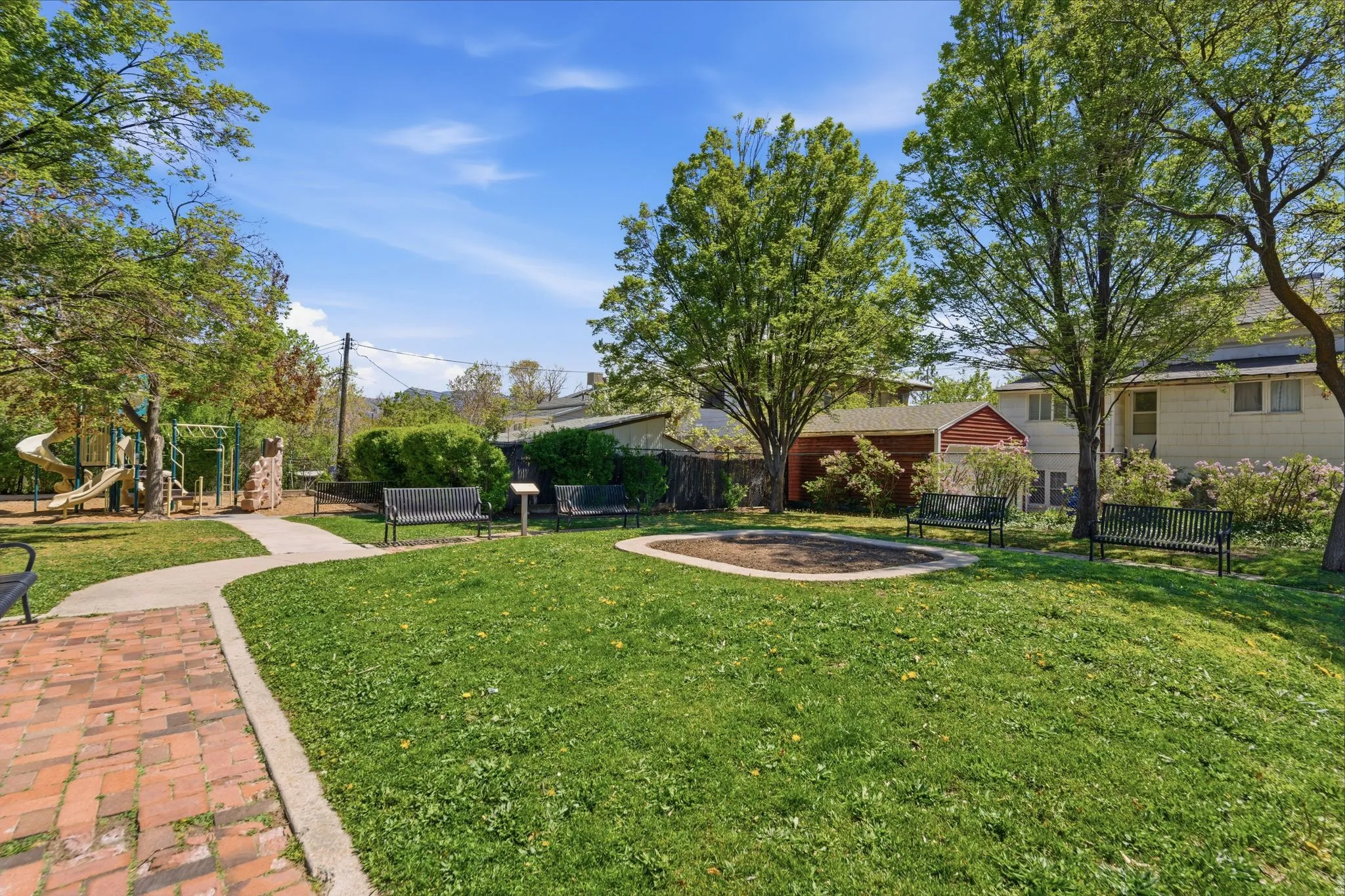 View of neighborhood park featuring a playground