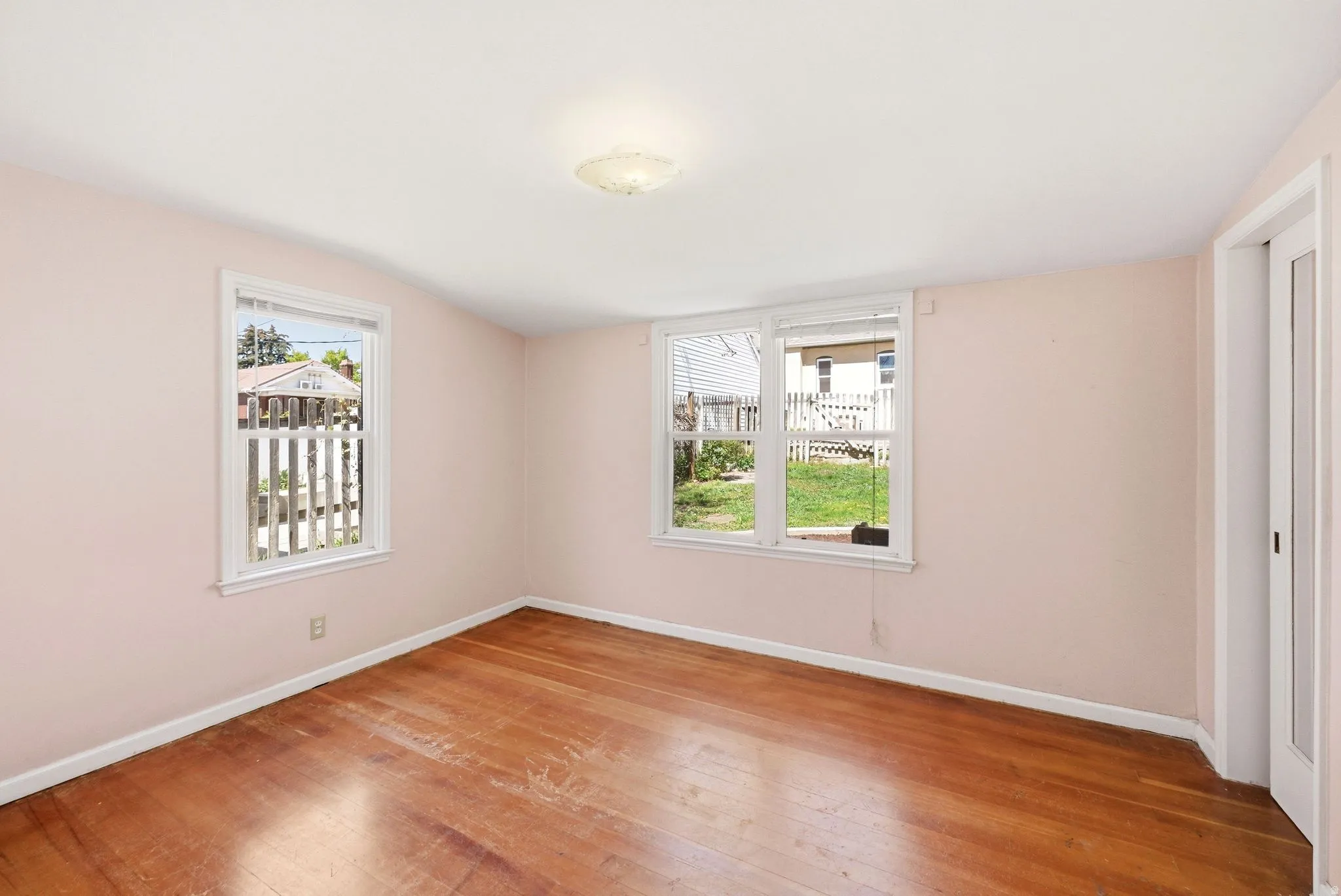 Empty room with baseboards and light wood-style floors