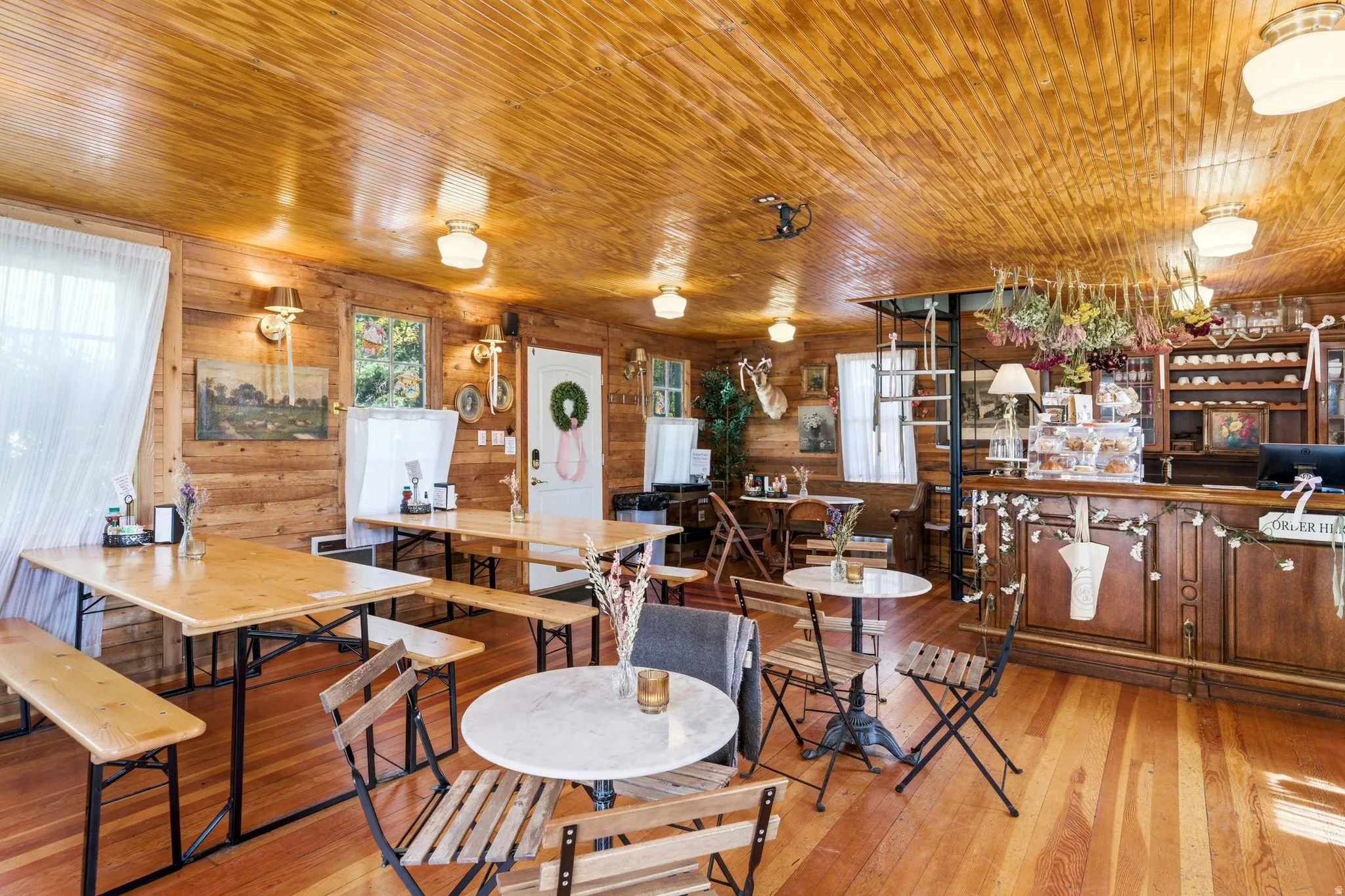 Cafe 140 B Historic Interior Dining area with hardwood / wood-style flooring, wooden ceiling, and wooden walls