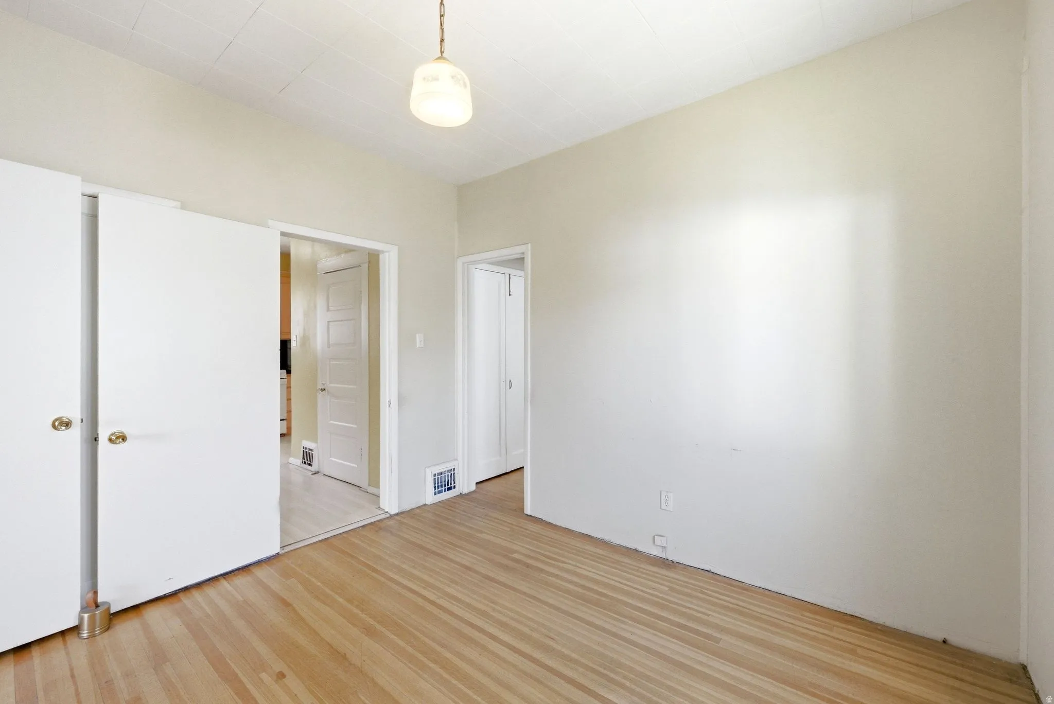 Unfurnished bedroom with light wood-type flooring