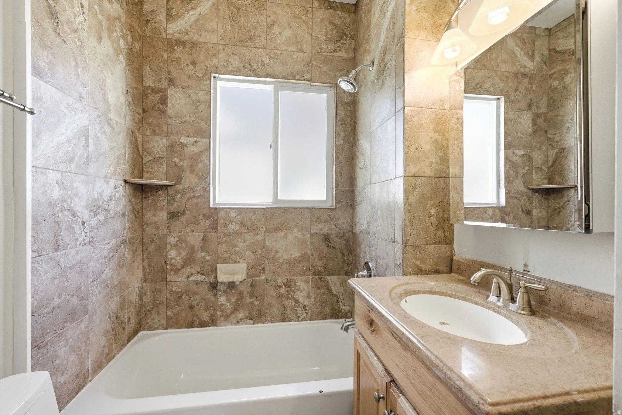 Full bath featuring vanity and  shower combination