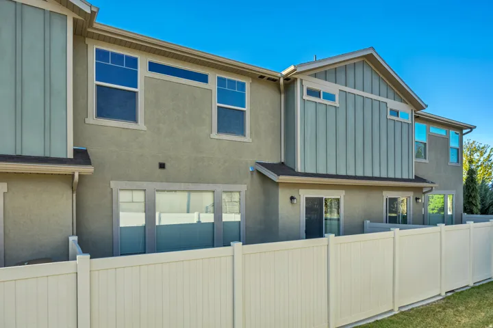 Back of property featuring board and batten siding and stucco siding