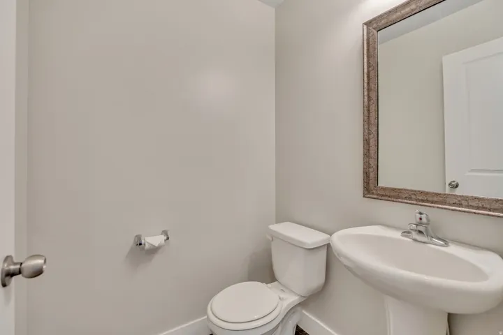 Bathroom with toilet and baseboards