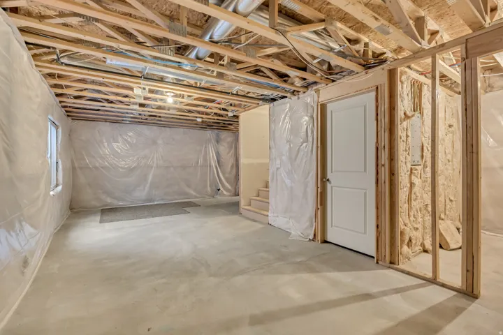 Unfinished basement featuring stairs