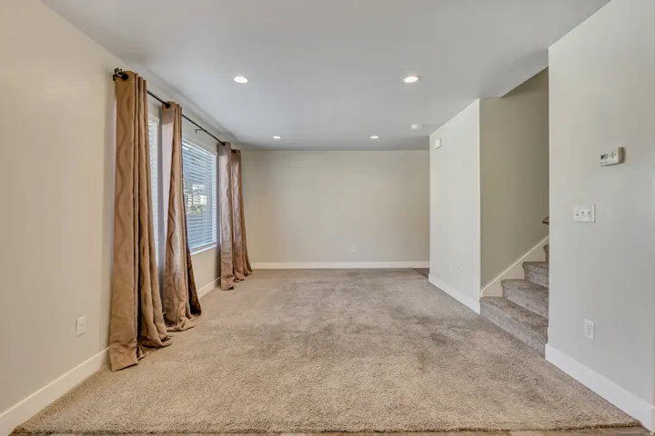 Unfurnished room featuring light carpet and recessed lighting