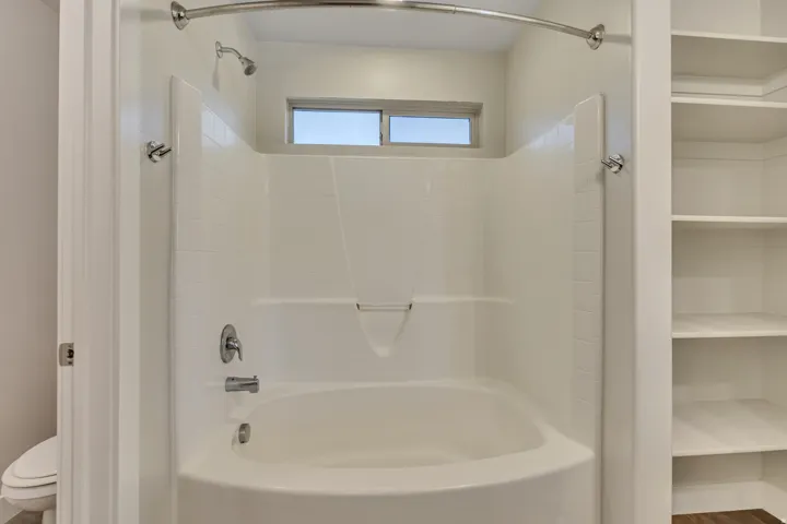 Bathroom featuring toilet and bathing tub / shower combination