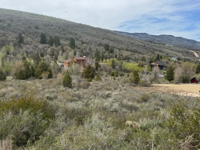 View of mountain backdrop featuring rural landscape