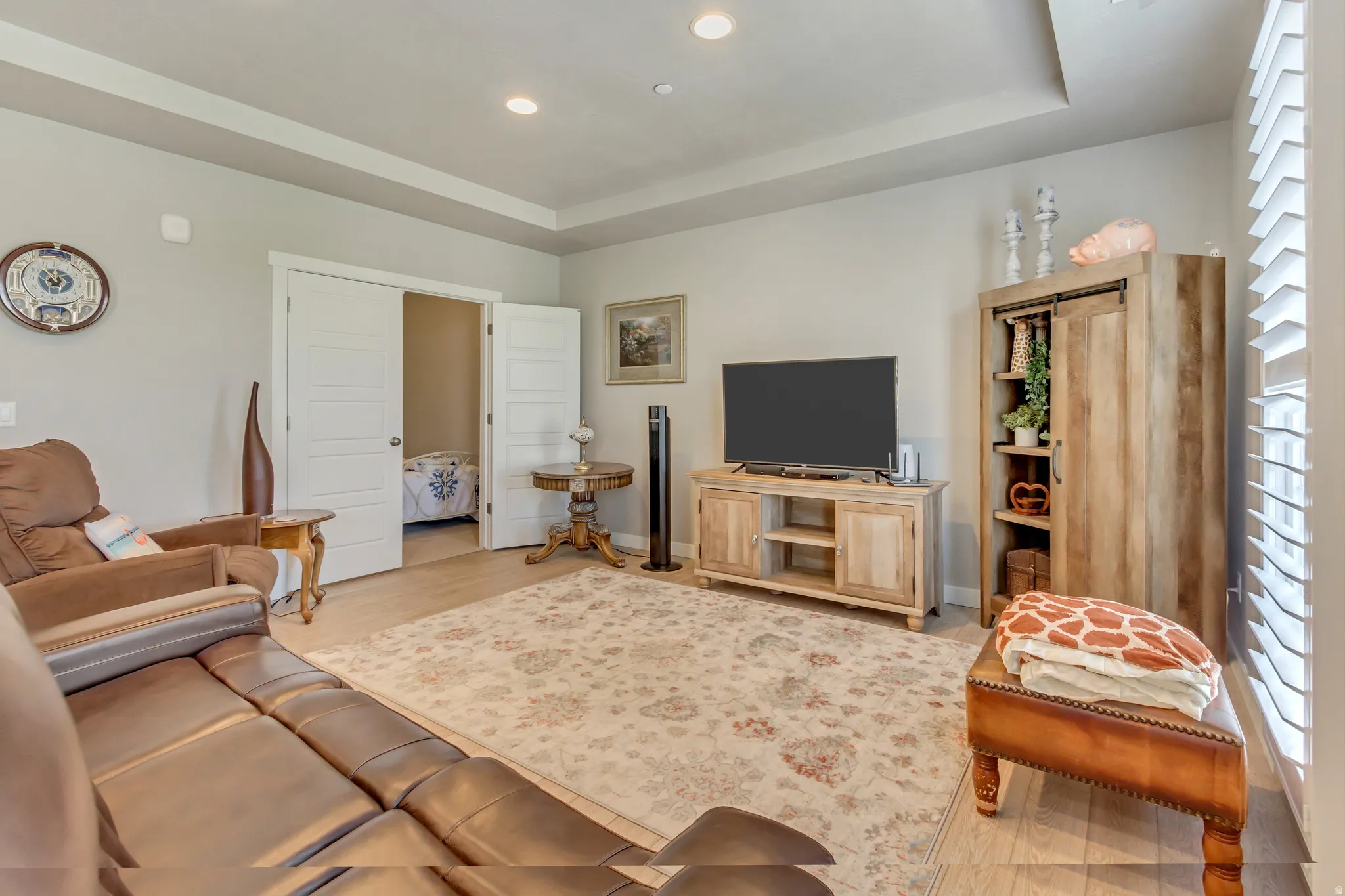 Living room featuring a tray ceiling and recessed lighting