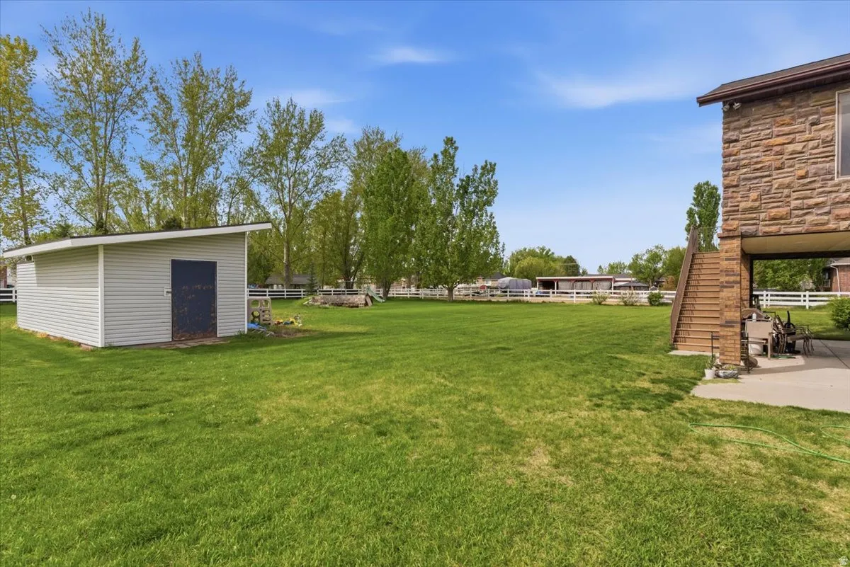 View of yard featuring stairway and an outdoor structure