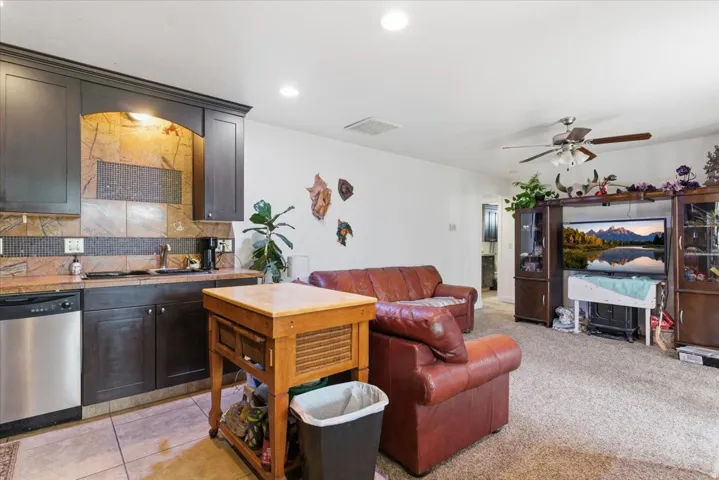 Living area with a ceiling fan and recessed lighting