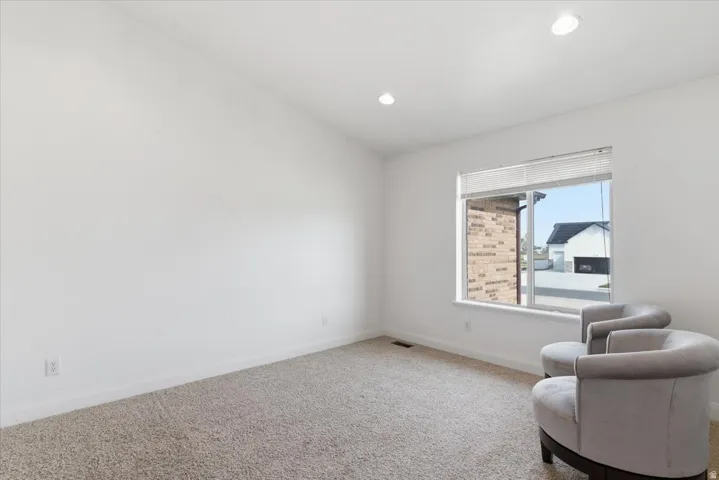 Living area featuring carpet floors and recessed lighting