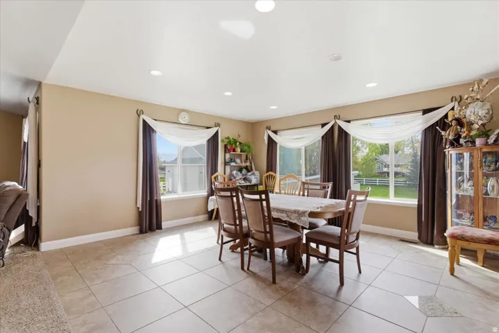 Dining area featuring light tile patterned floors and recessed lighting