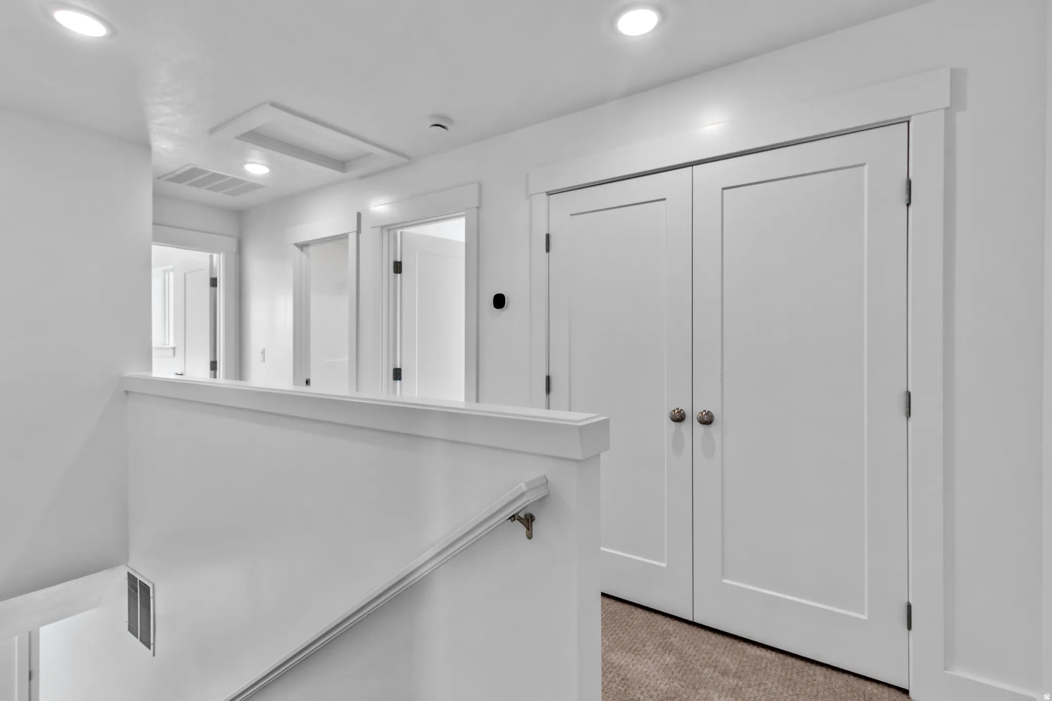 Corridor with attic access and recessed lighting