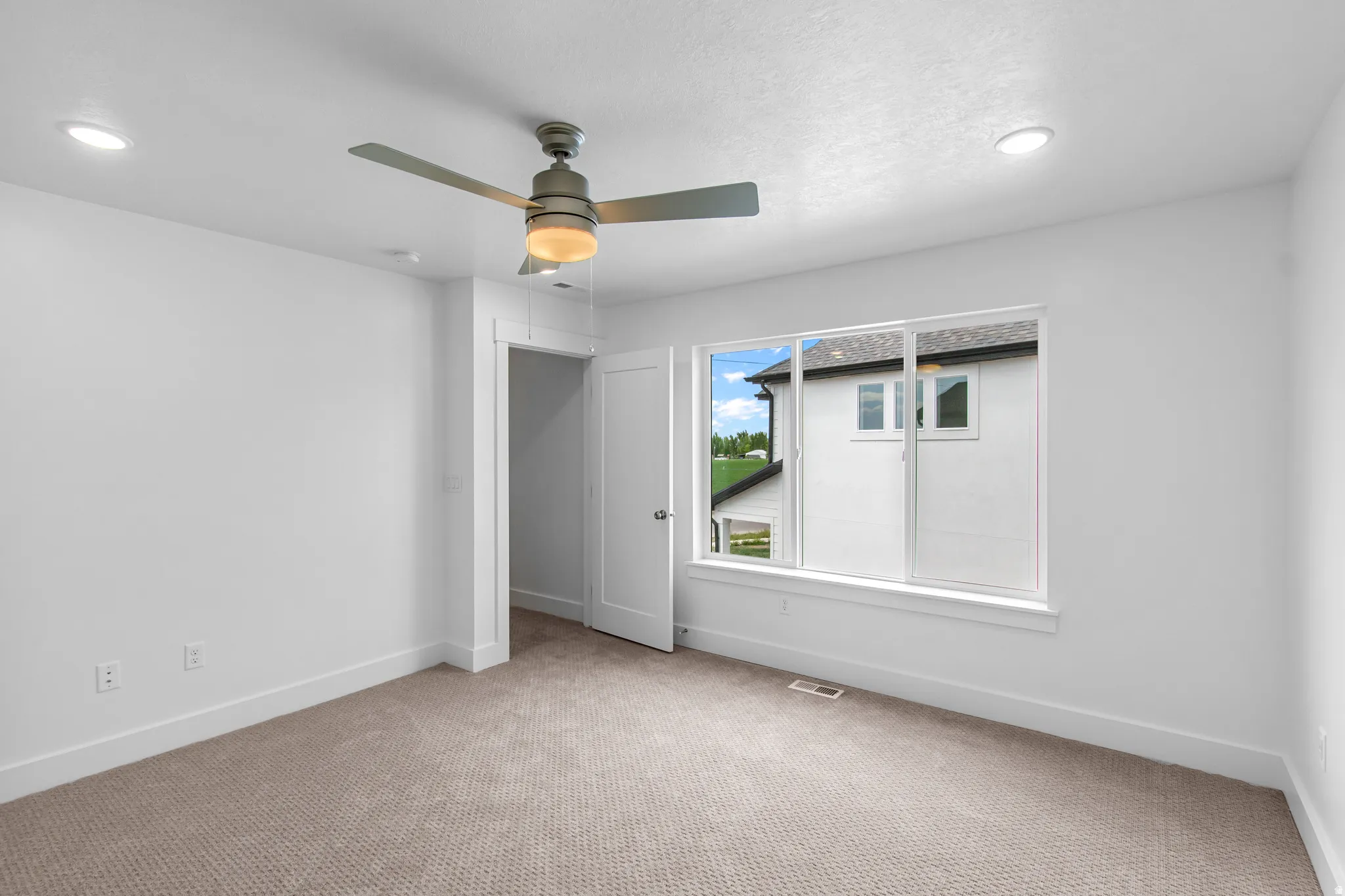 Unfurnished bedroom featuring carpet, a ceiling fan, and recessed lighting