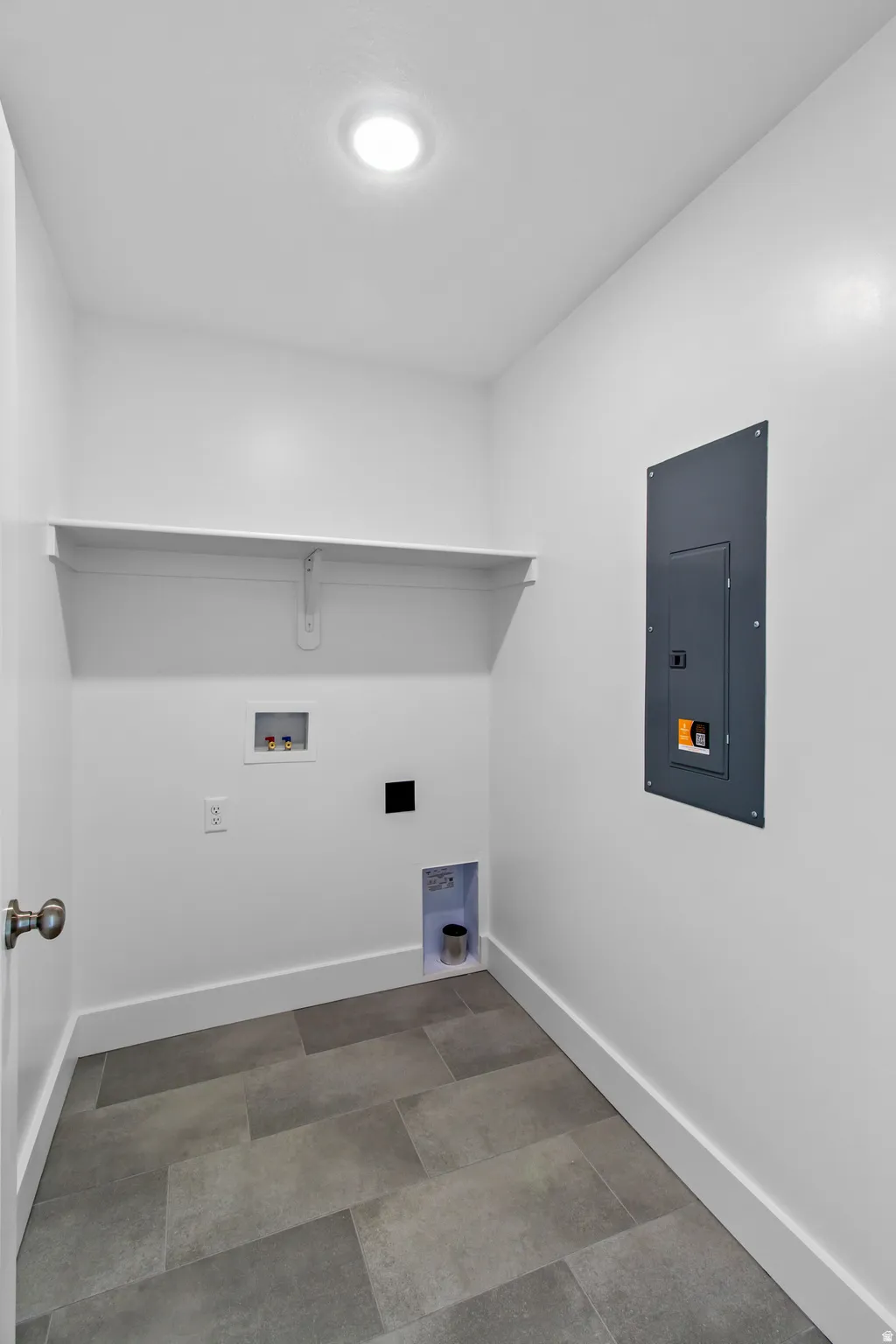 Laundry area with electric panel and hookup for a washing machine