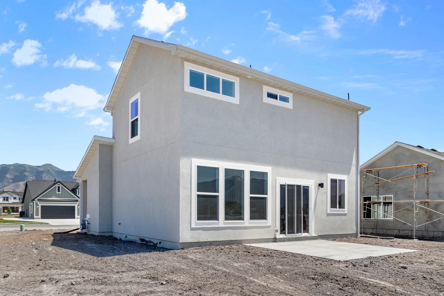 Back of property featuring a patio, a mountain view, and stucco siding