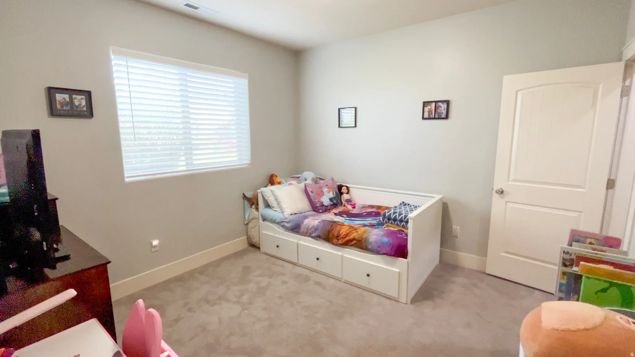 Bedroom featuring light colored carpet and baseboards