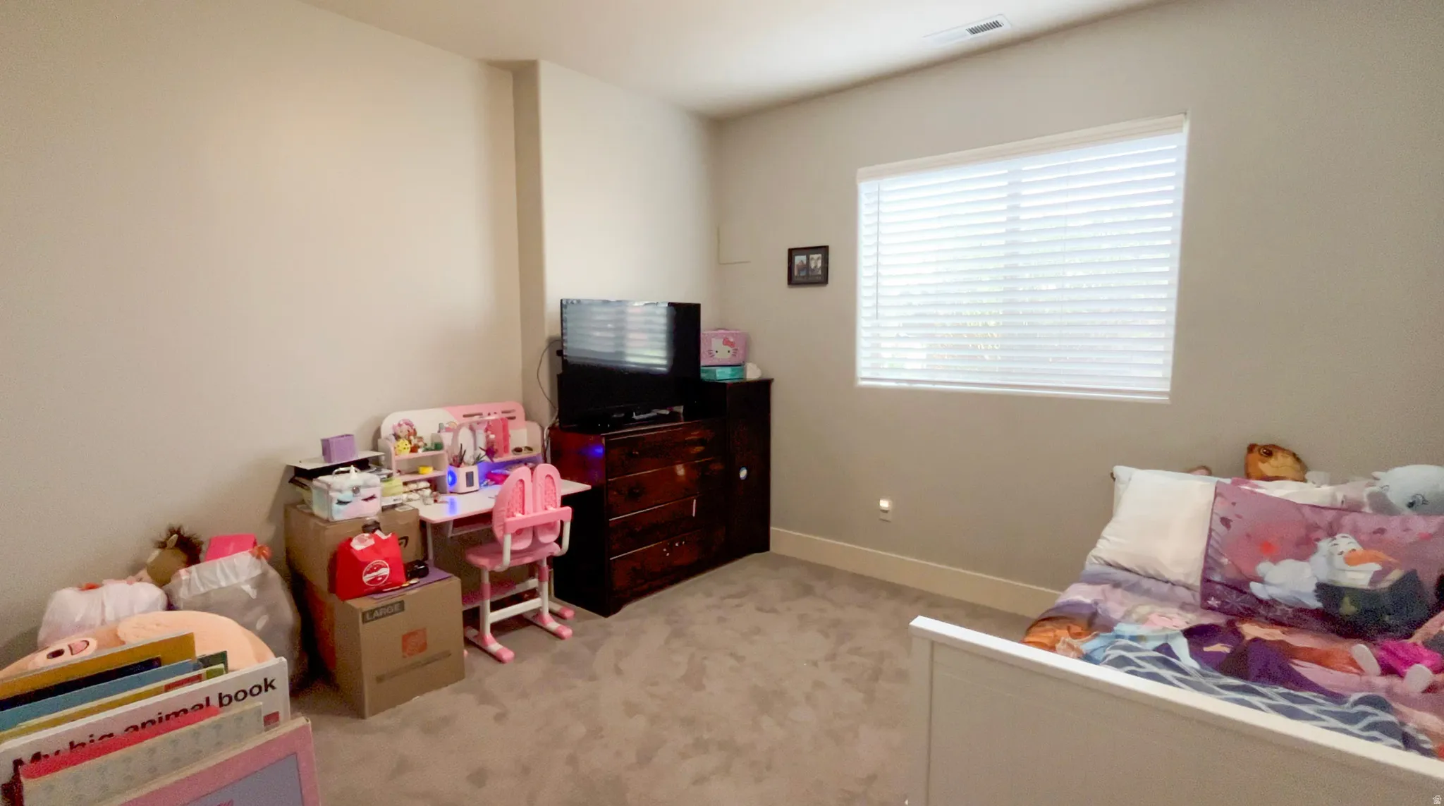 Bedroom with light carpet and baseboards