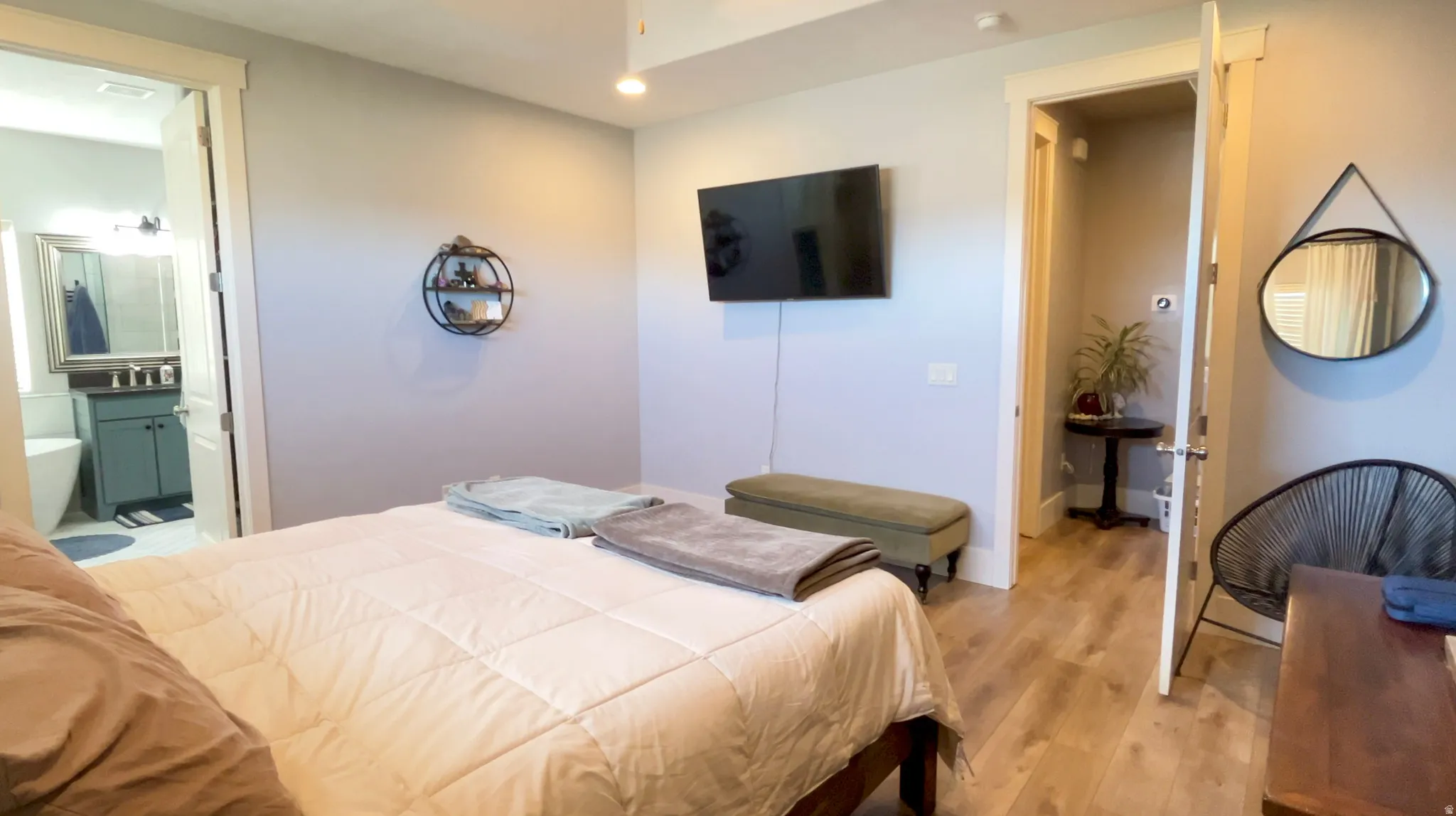 Bedroom featuring wood finished floors, recessed lighting, and ensuite bathroom