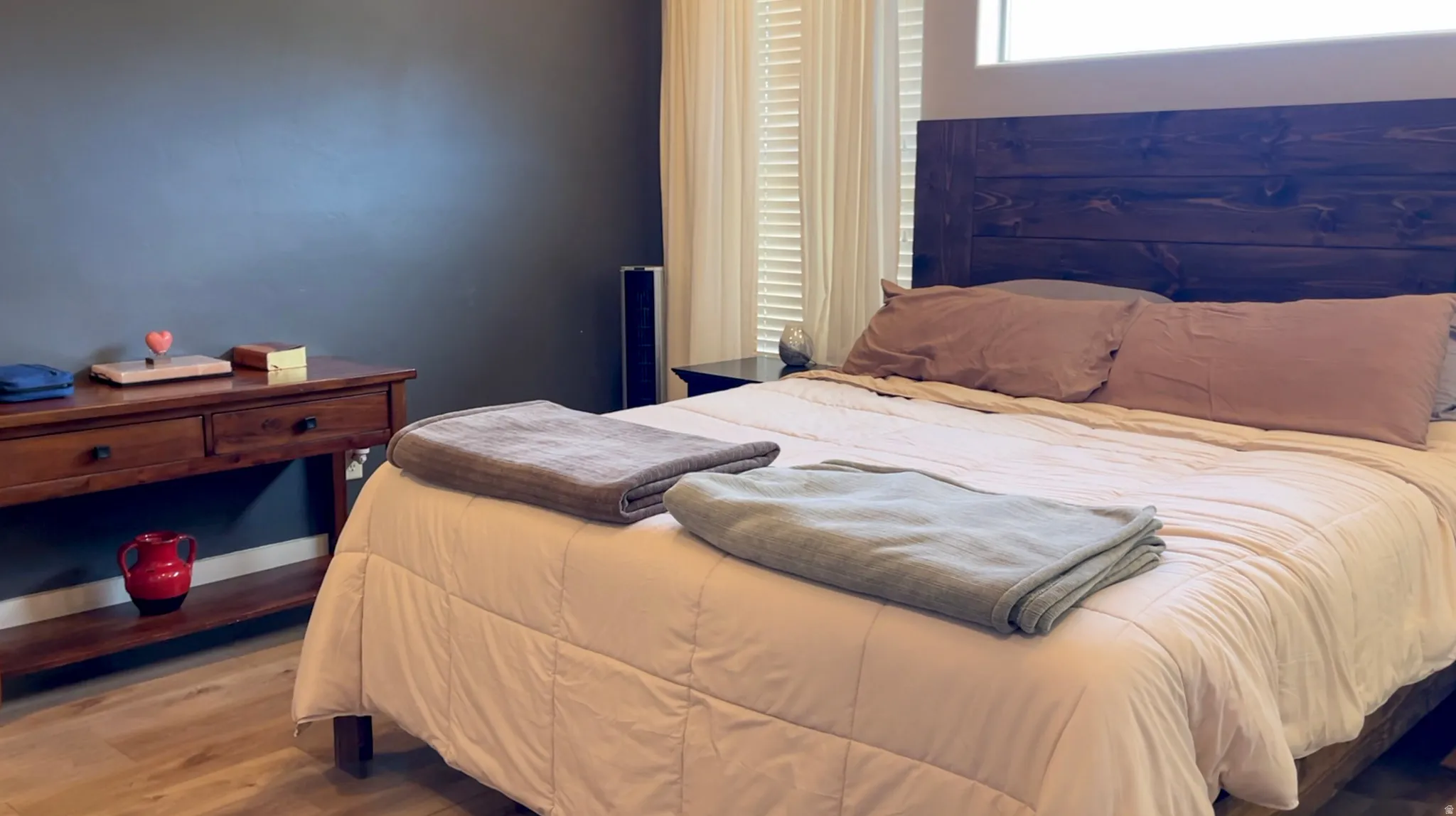 Bedroom featuring wood finished floors and baseboards