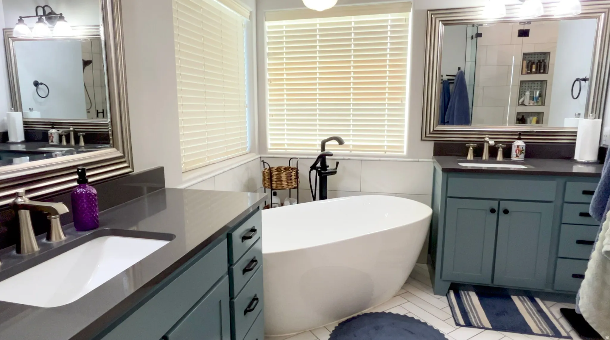 Bathroom featuring a freestanding tub and two vanities
