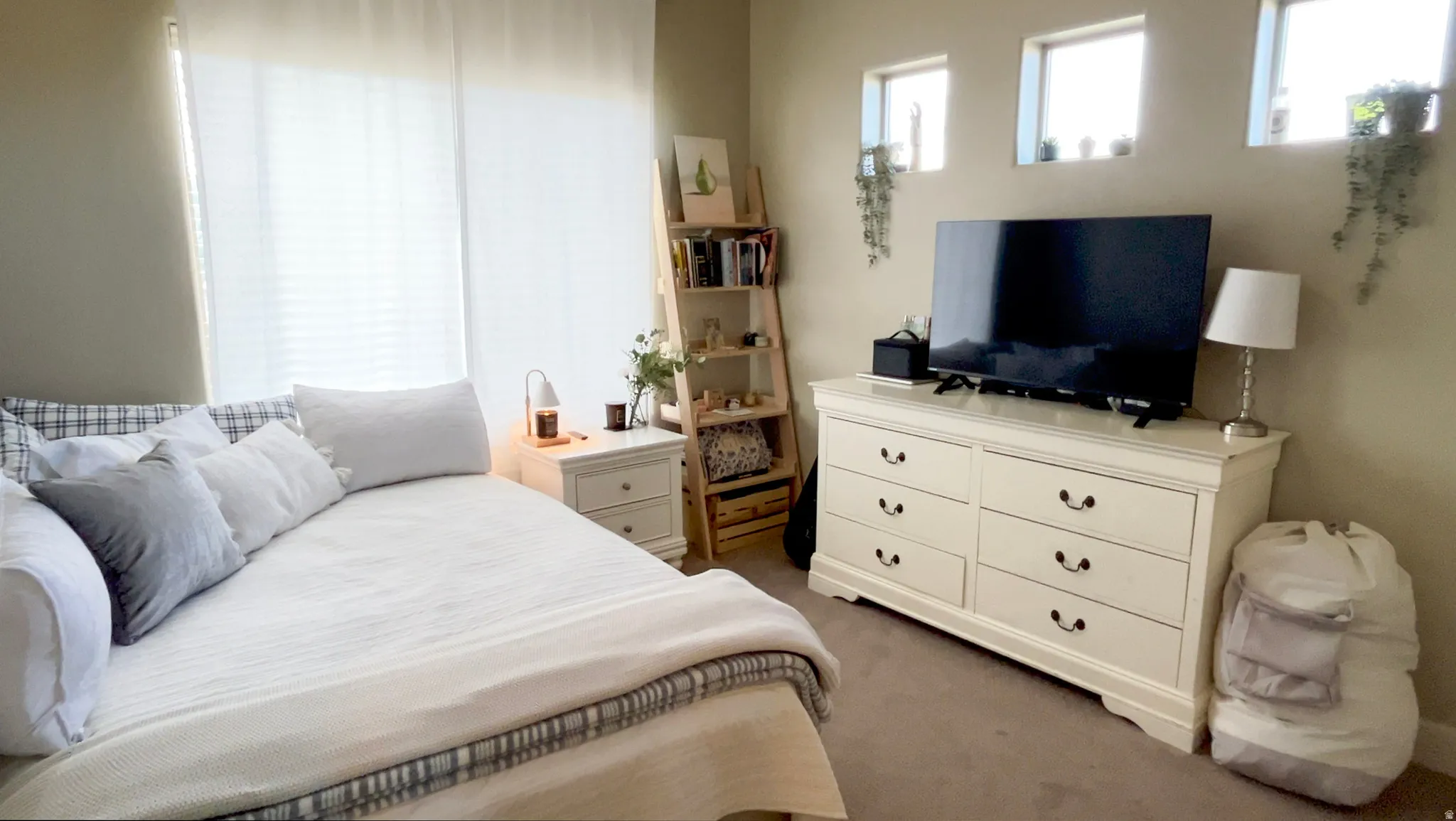 Bedroom featuring light carpet