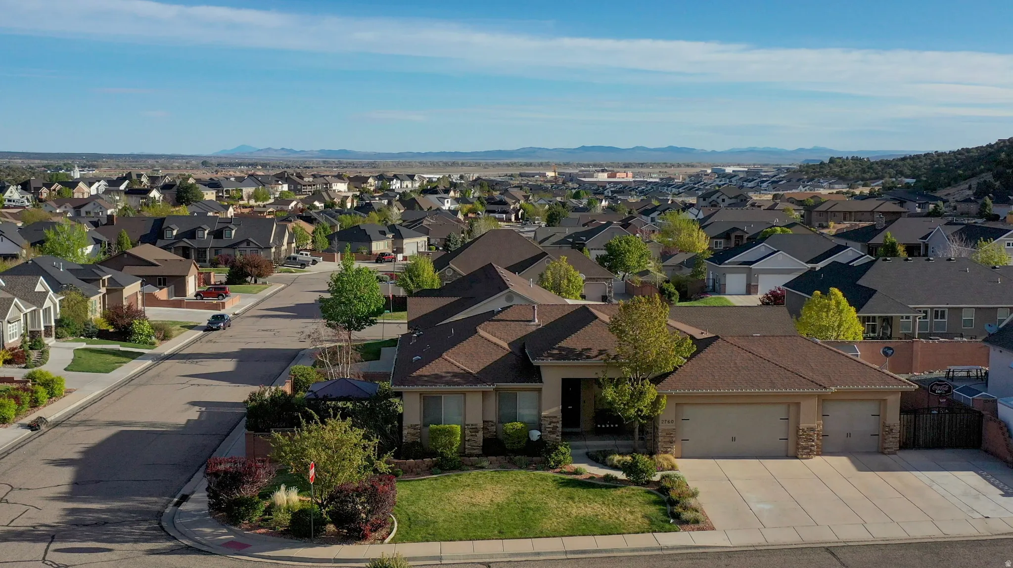 Aerial view of residential area featuring a mountainous background