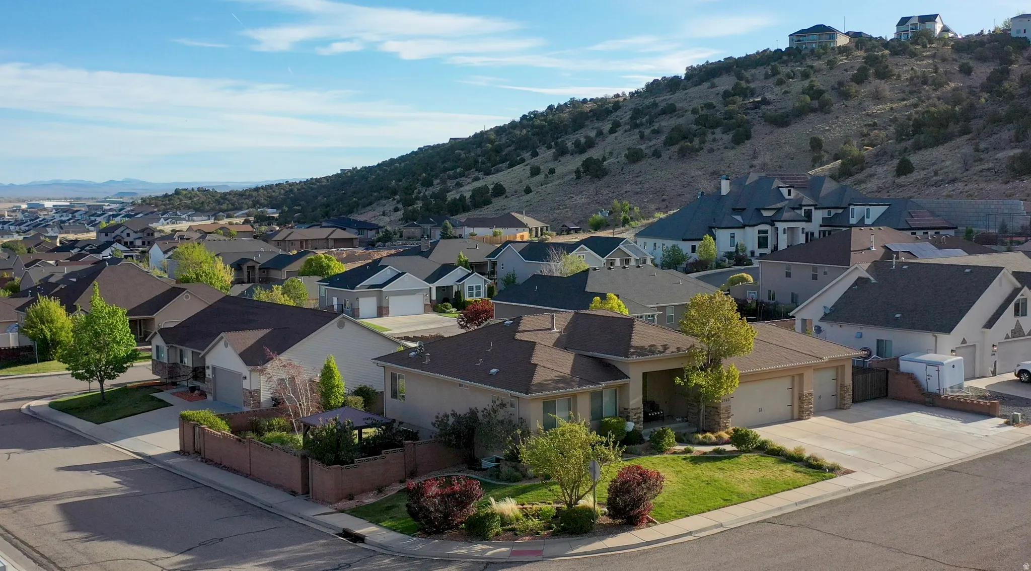 Aerial perspective of suburban area featuring a mountainous background