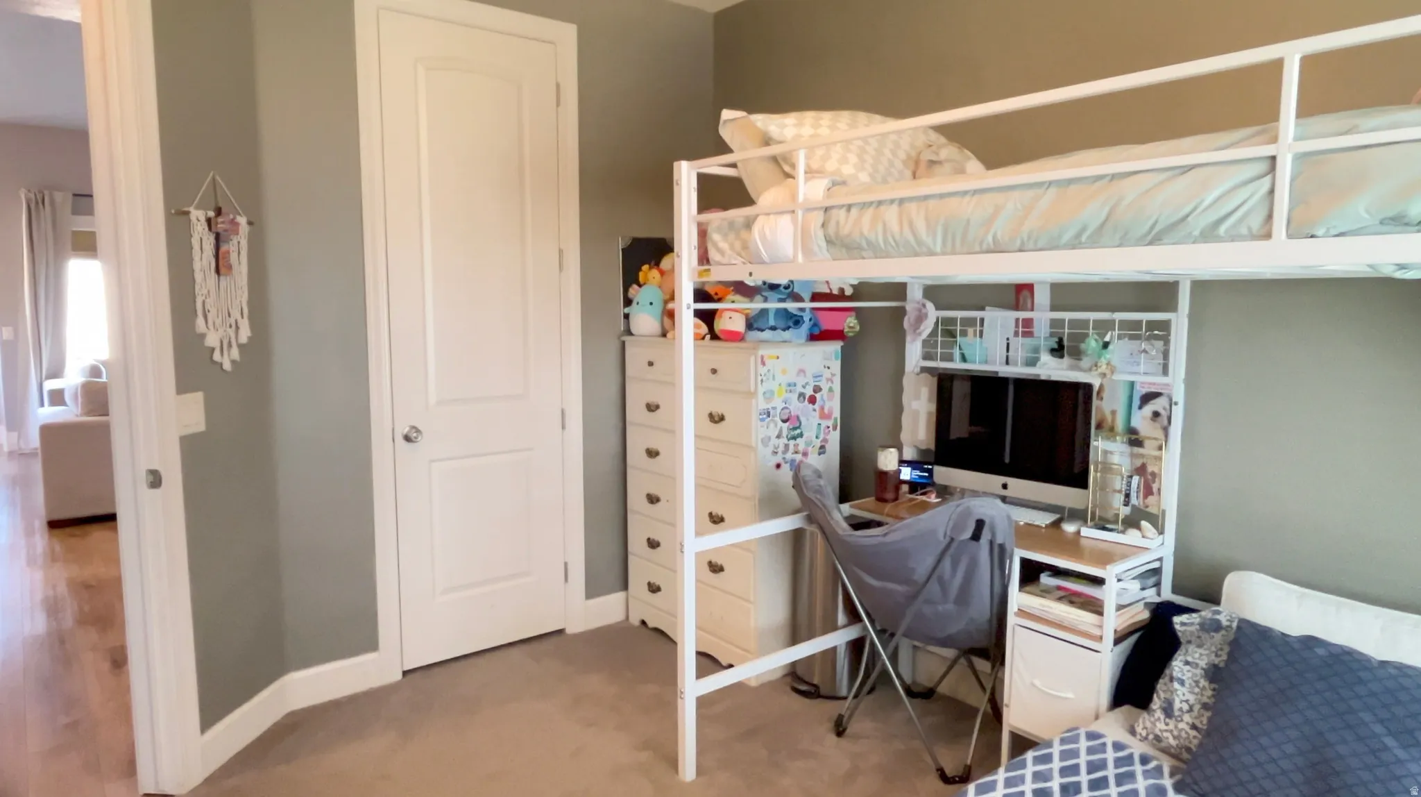 Bedroom with baseboards and light carpet