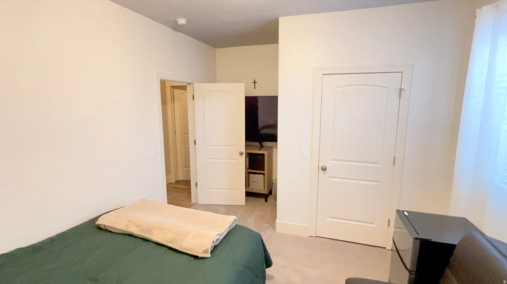 Bedroom with black fridge