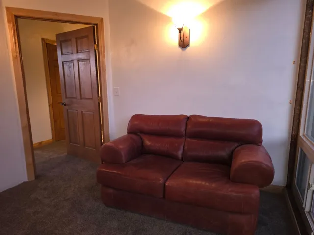 Carpeted living area featuring baseboards