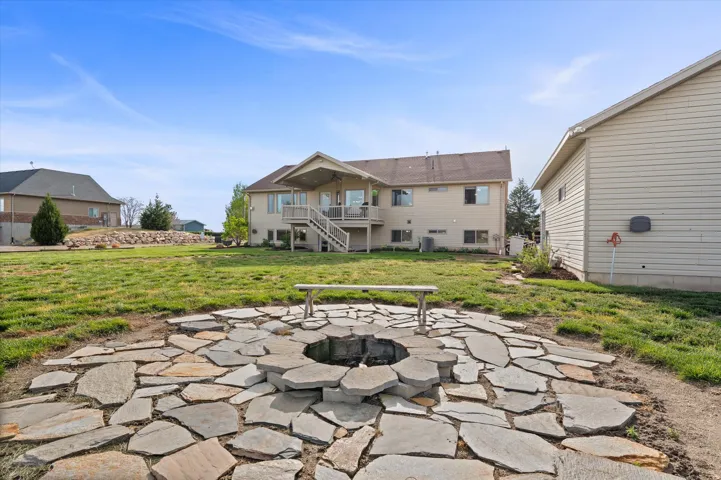 Patio / terrace with a patio area, a fire pit, and a lawn