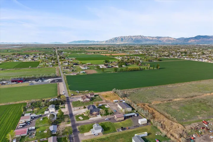 Overview of rural landscape with large plots for crops and a mountainous background