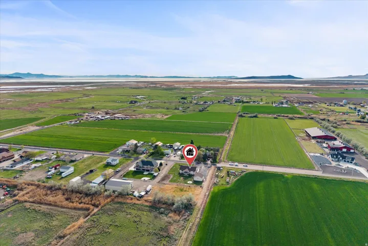 Aerial overview of property's location with rural landscape, a mountainous background, and extensive farmland