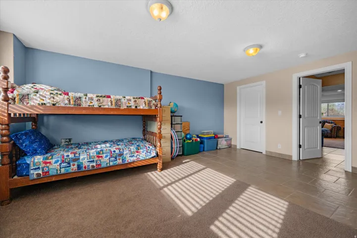 Bedroom featuring a textured ceiling and baseboards