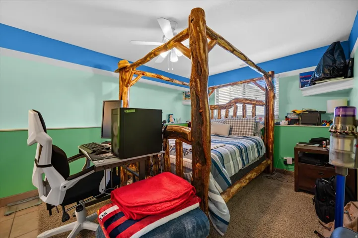 Bedroom featuring ceiling fan and baseboards