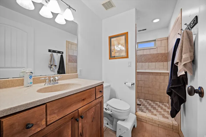 Bathroom featuring vanity and walk in shower