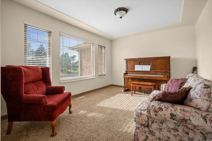 Living area with carpet flooring and baseboards