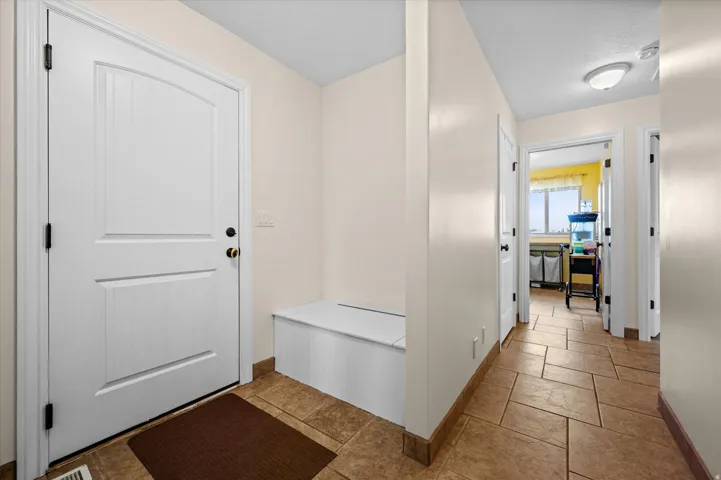 Mudroom featuring baseboards and a textured ceiling