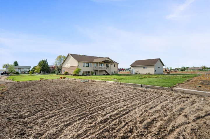 View of front facade with a front lawn and stairway