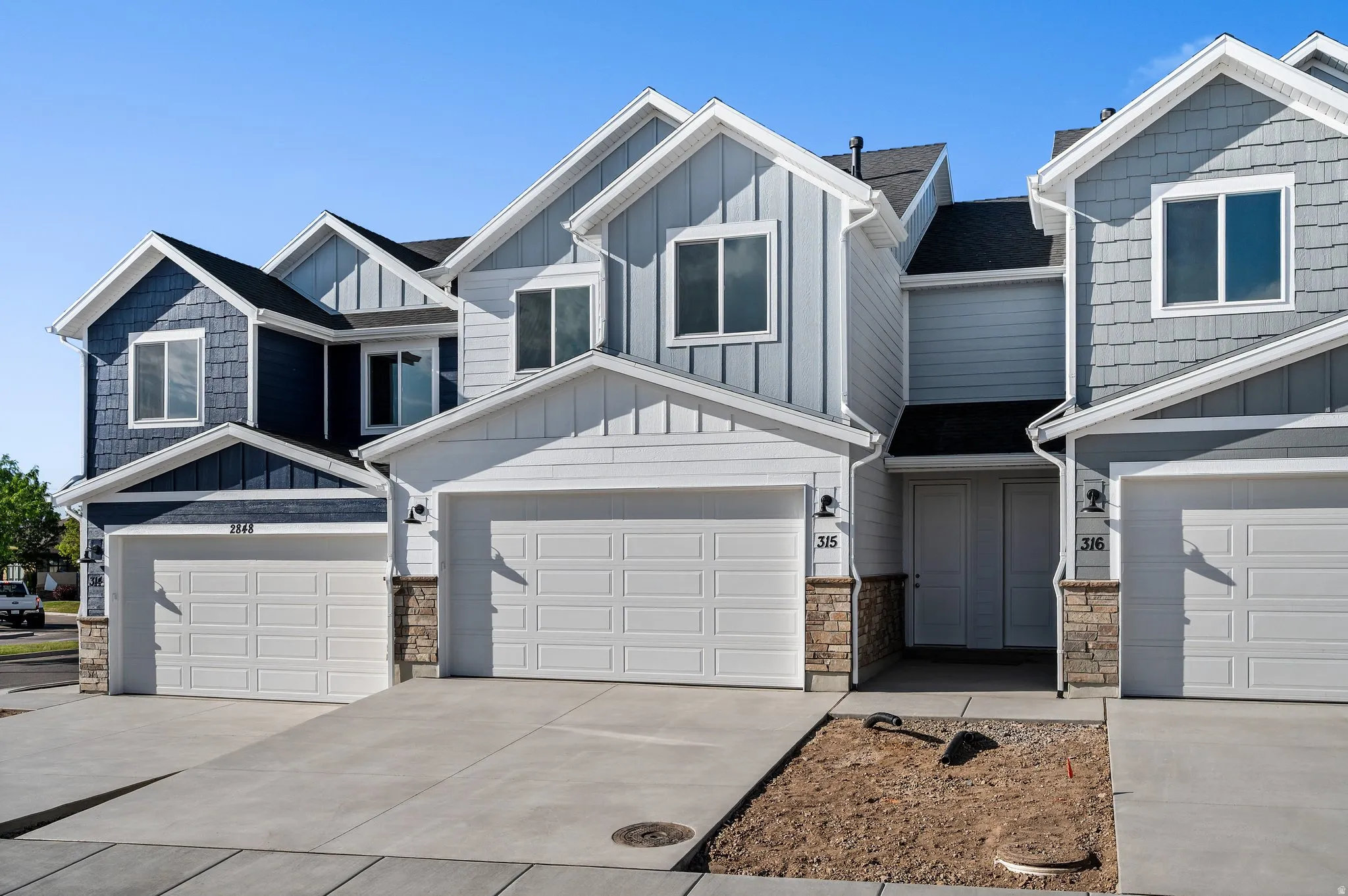 Contemporary townhome-style residences featuring a mix of horizontal siding and shake siding