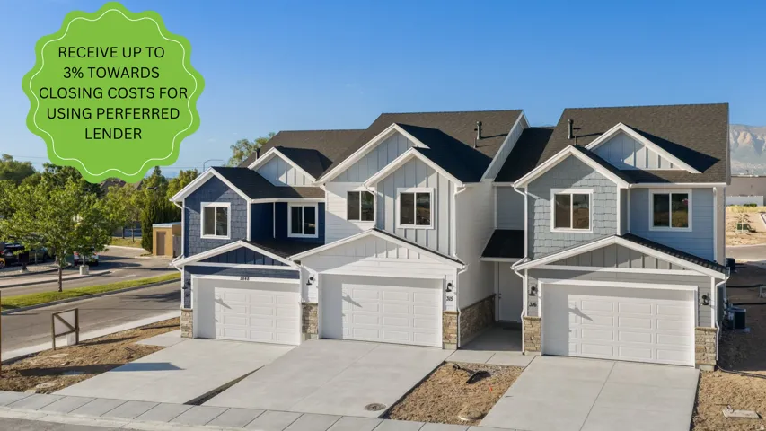Modern townhome exterior featuring varied siding textures, stone accents, and attached garages