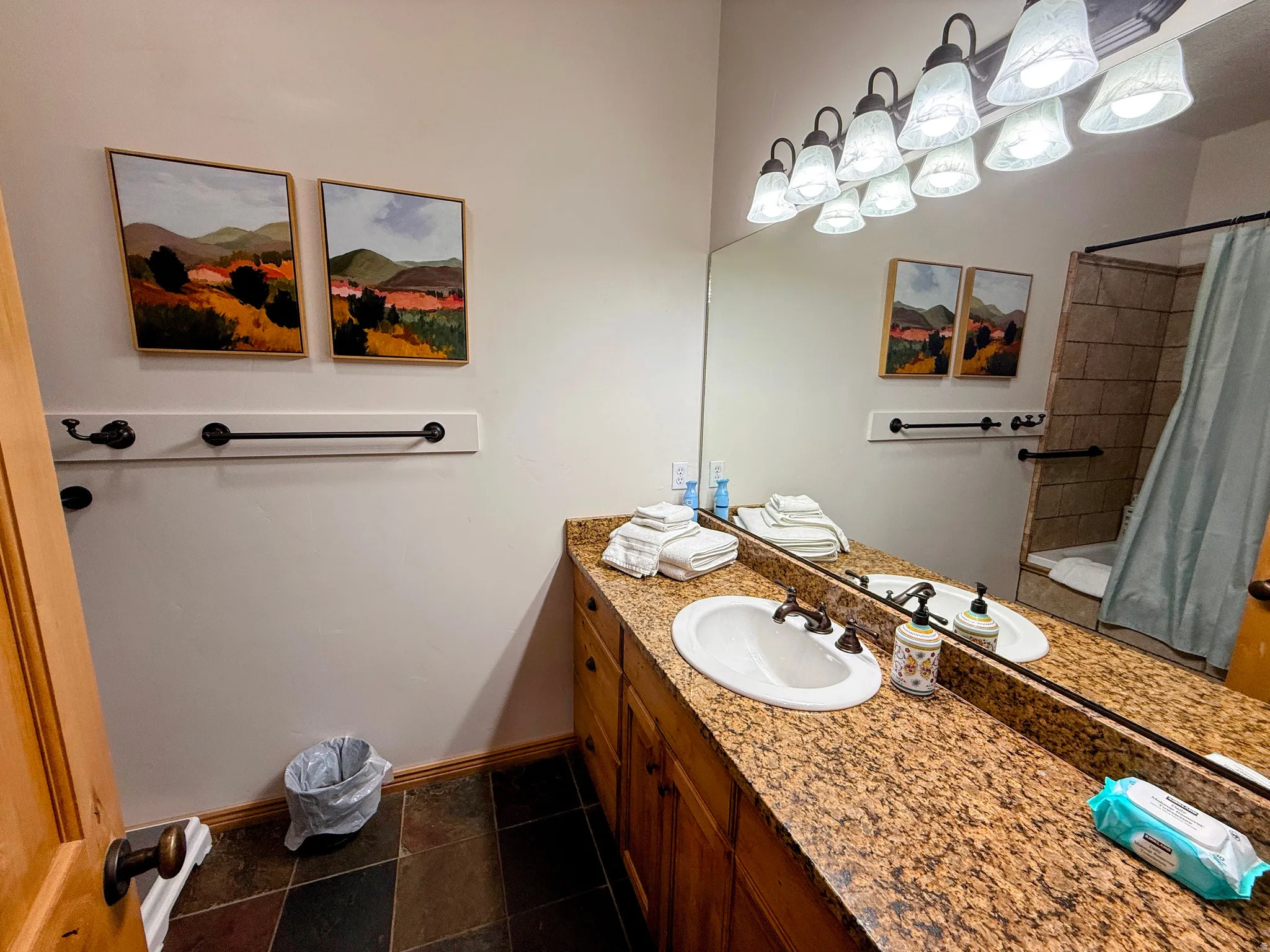 Full bath featuring vanity and baseboards
