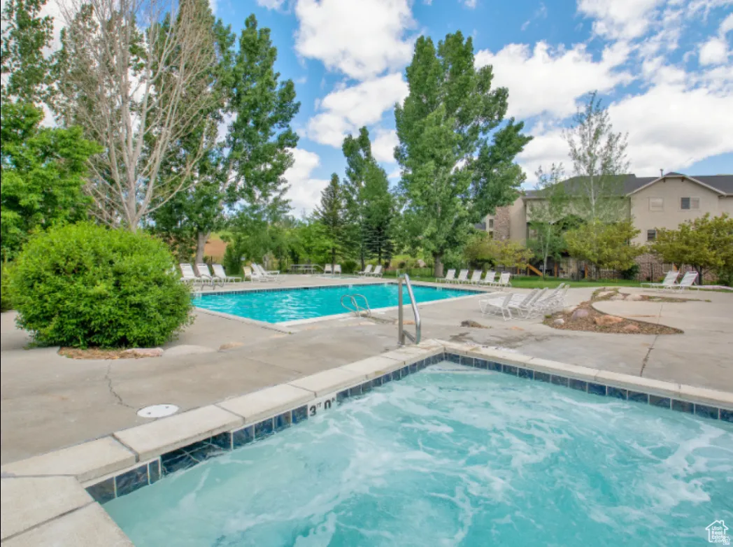 Community pool with a patio