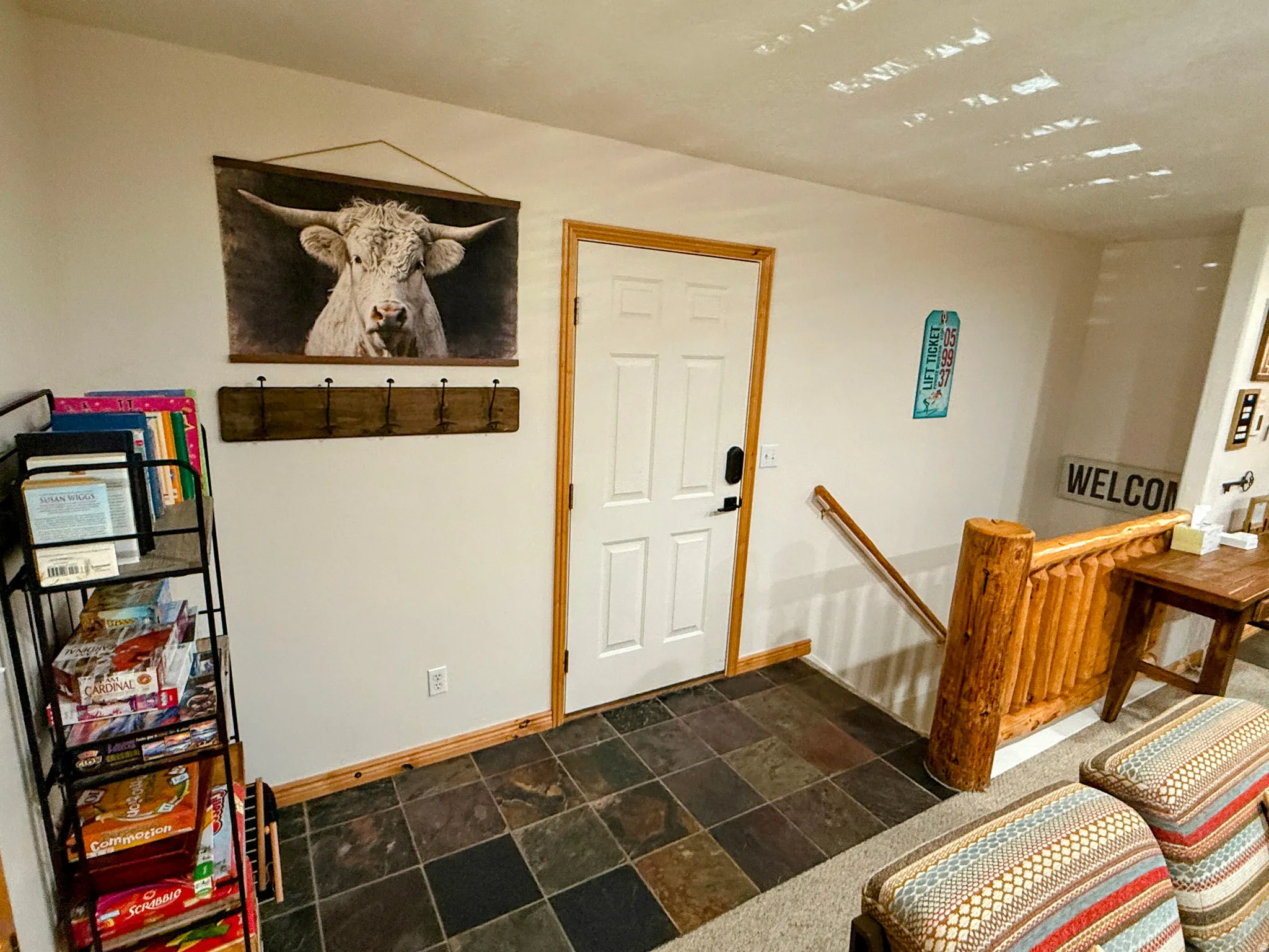 Entrance foyer featuring baseboards and stone tile flooring