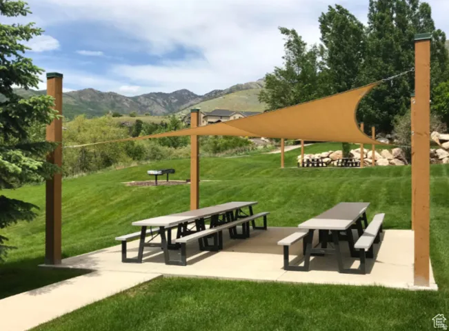View of property's community featuring a mountain view and a patio