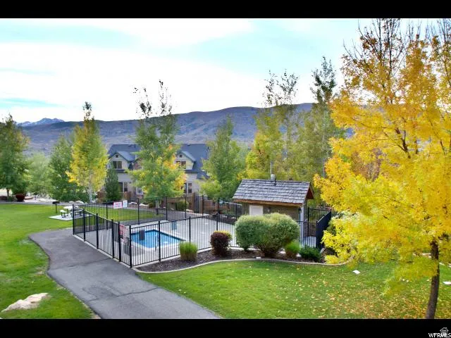 View of property's community with a swimming pool and a mountain view